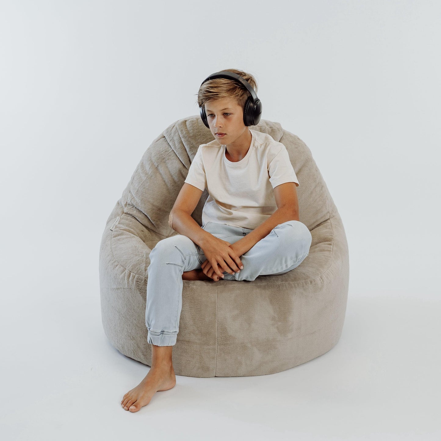 Light beige bean bag chair cover with soft fabric surface and stitched side seams