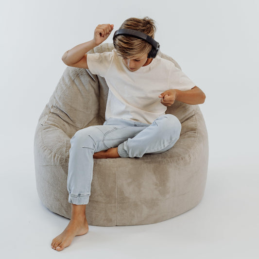 Light beige bean bag chair cover in large rounded shape, with clean seam panels