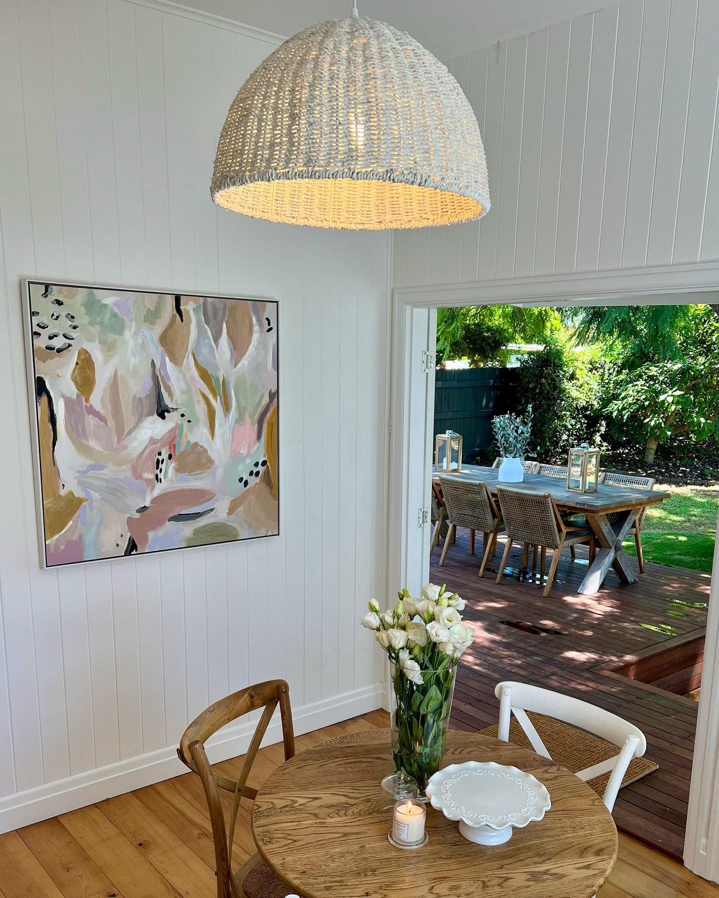 Rope-woven dome pendant light, light beige over dining table.
