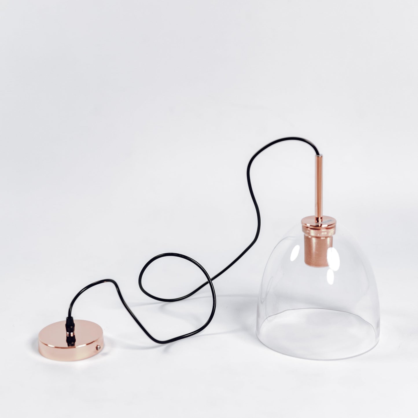 Copper glass pendant light with clear bell shade and rose-gold canopy base