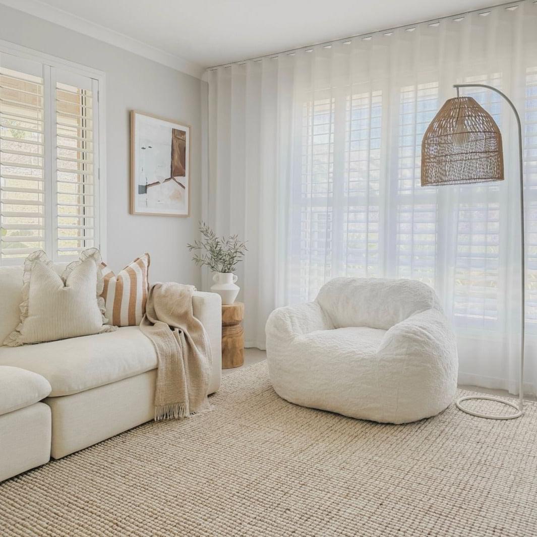 Off-white plush bean bag chair with thick cushion and rounded shape