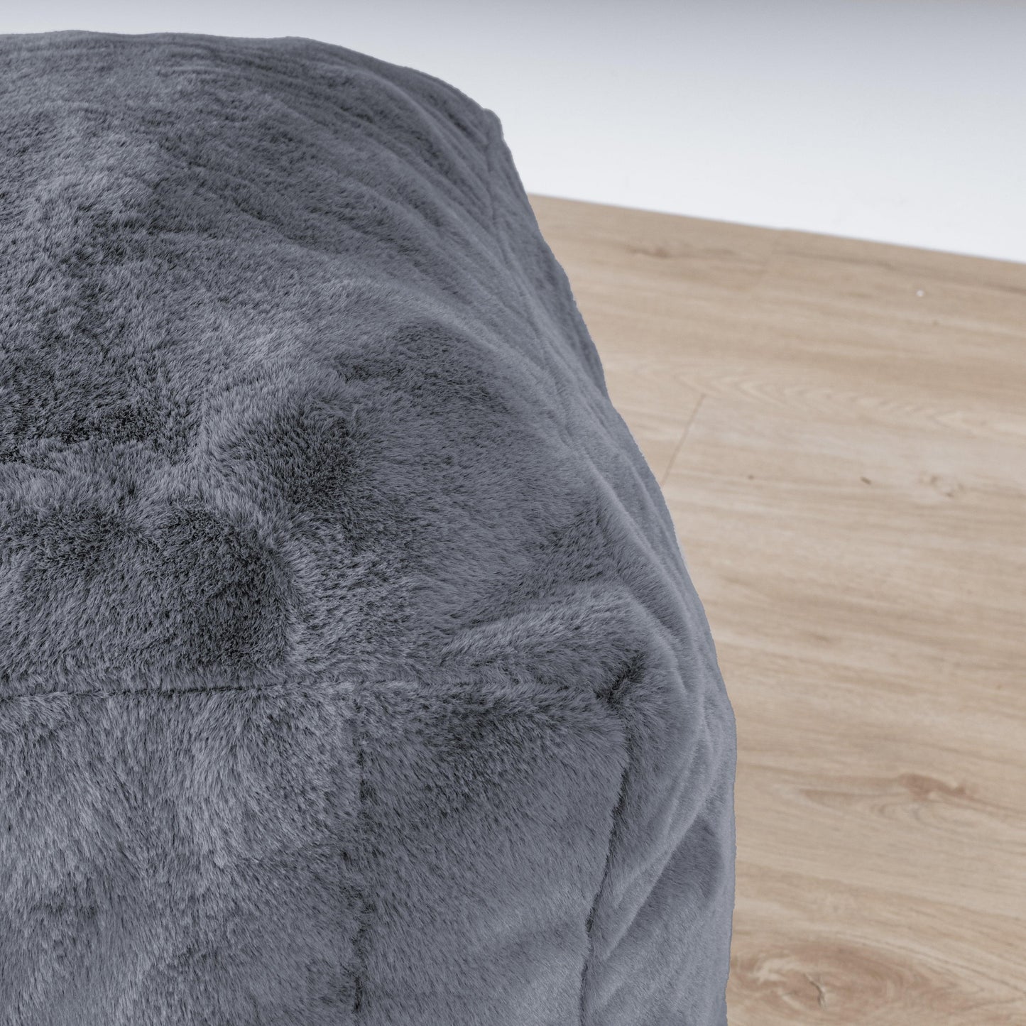 Charcoal gray textured fabric ottoman corner detail