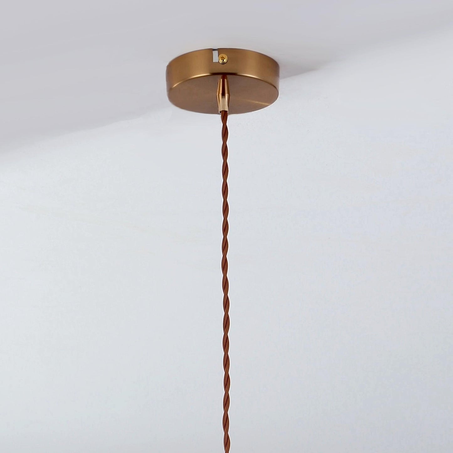 Braided-cord pendant light with gold ceiling mount and top connector