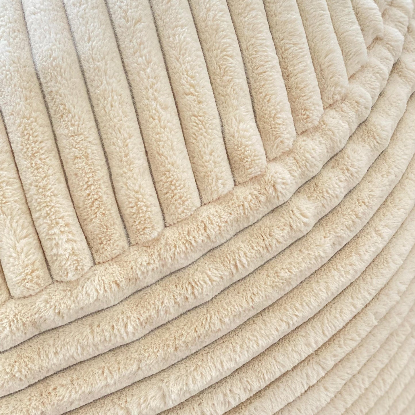 Cream channel-cord plush ridges with tufted channel texture