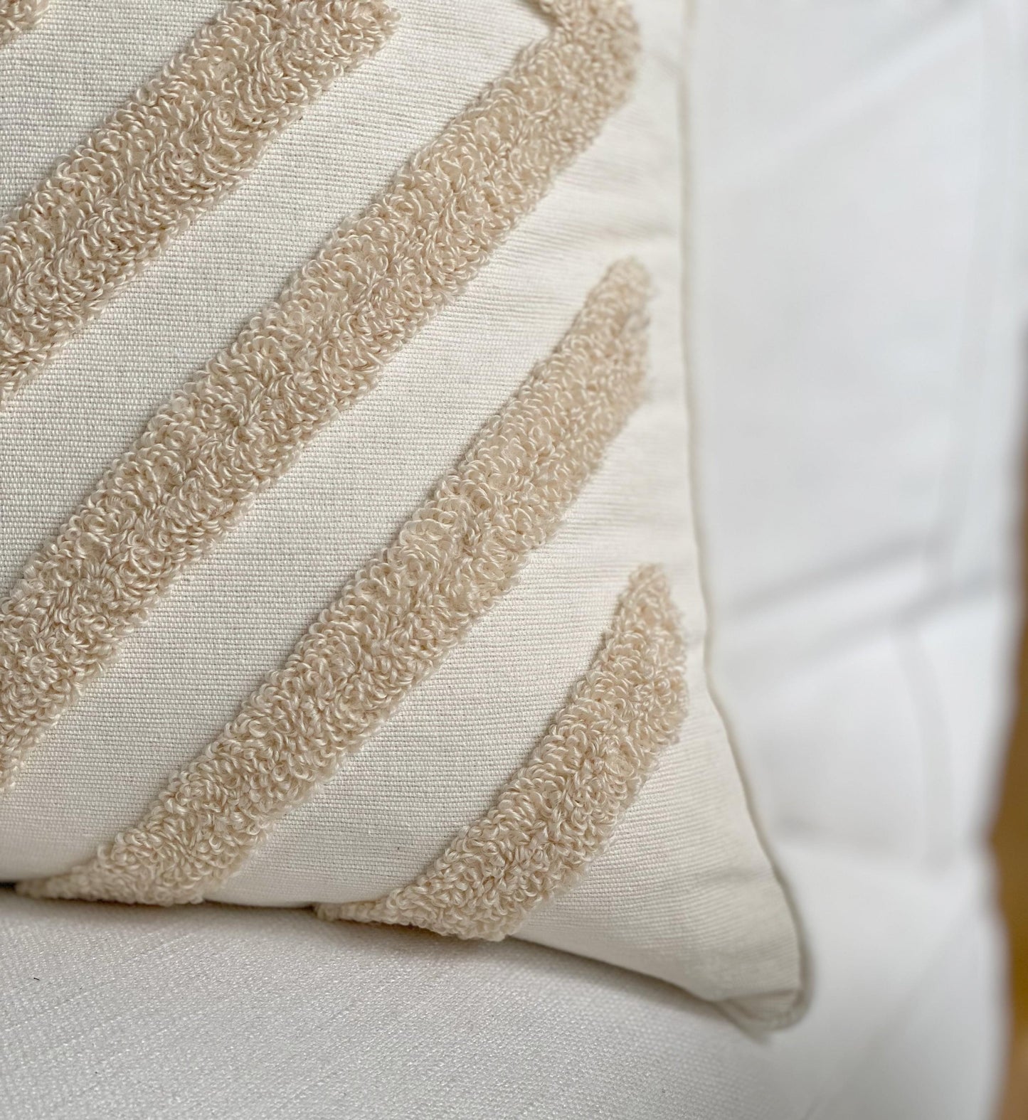 Tufted cushion cover with raised stripe and scalloped trim in cream