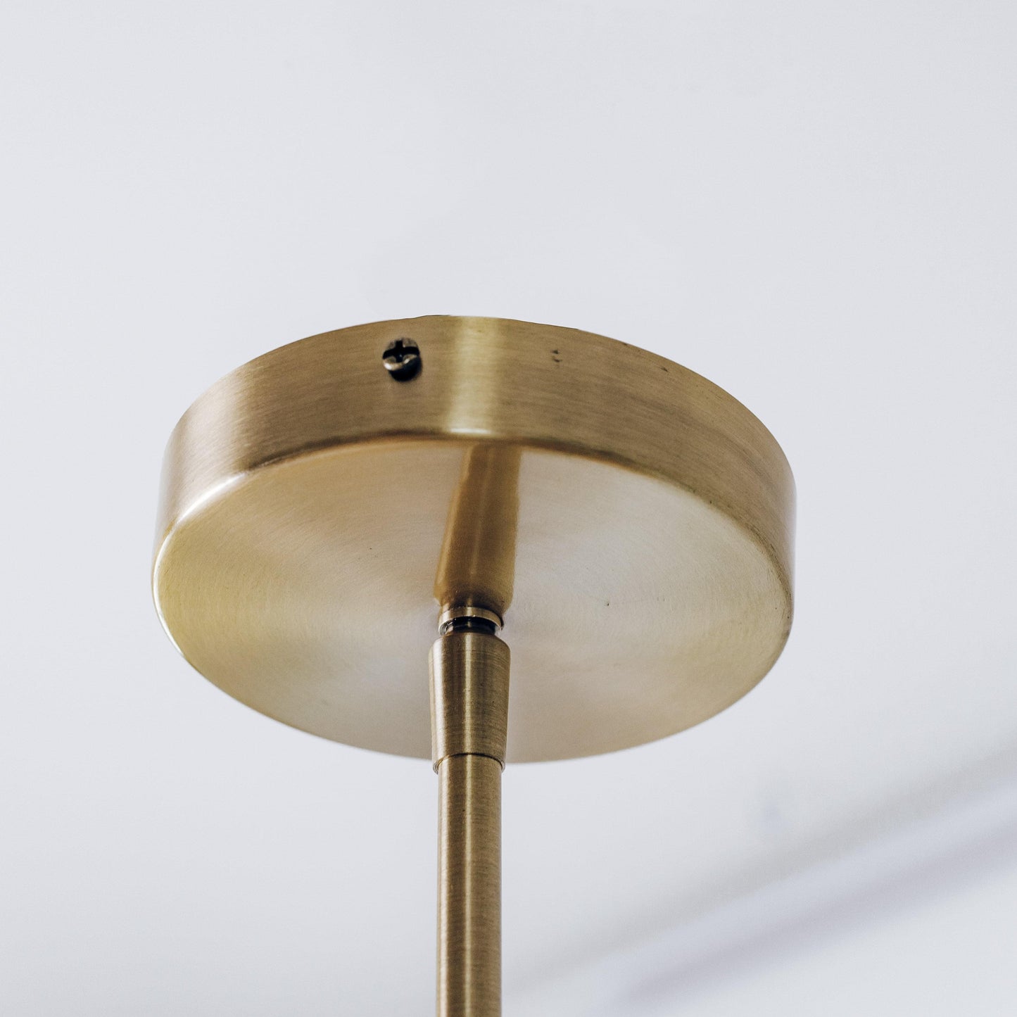 Brass ceiling mount for pendant light with central rod connection