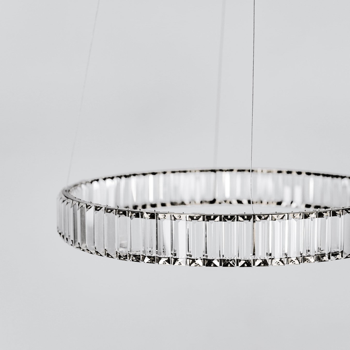 Round LED chandelier with clear faceted crystal ring and vertical prism strands