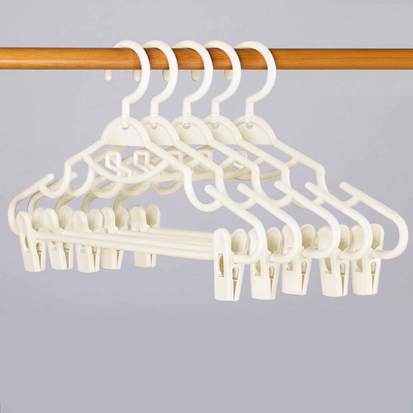 White plastic pants hanger with clips and curved hook, arched frame