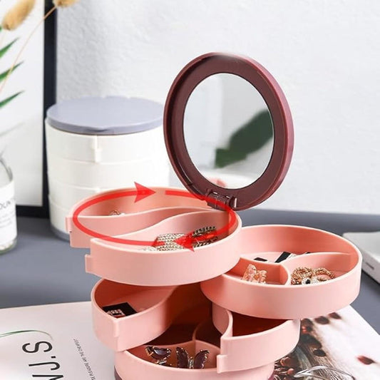 Pink rotating jewelry box with open spiral layers and oval mirror