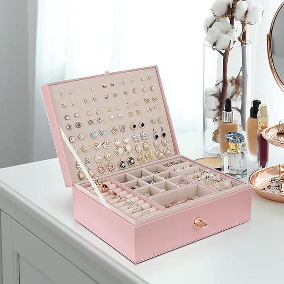 Pink jewelry box with open lid and many earring slots plus bracelet and ring areas