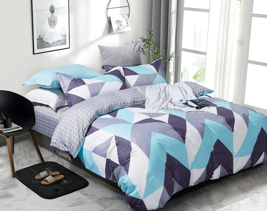 Geometric teal, navy, and white duvet cover set with pillows on bed