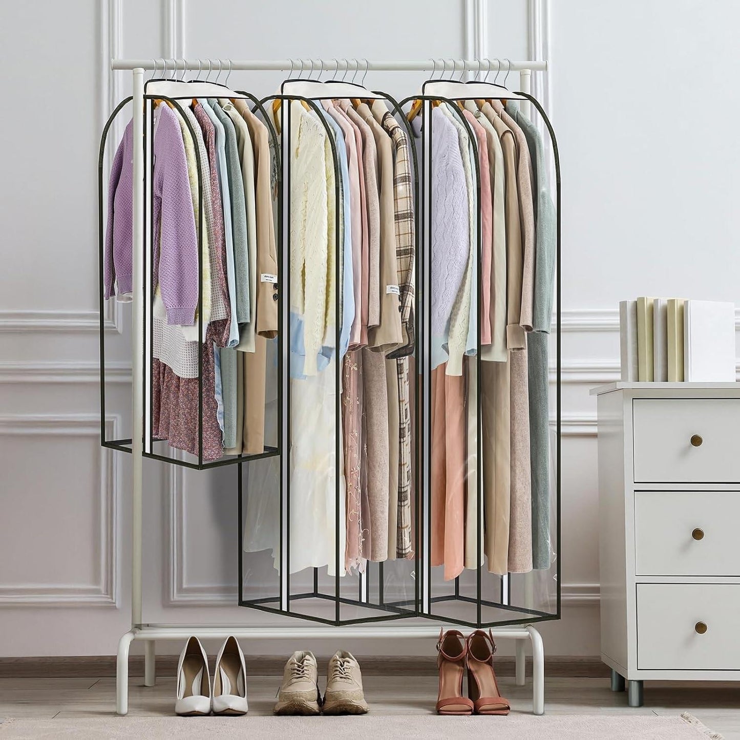 Clear hanging garment cover with zippers, holding multiple coats and dresses