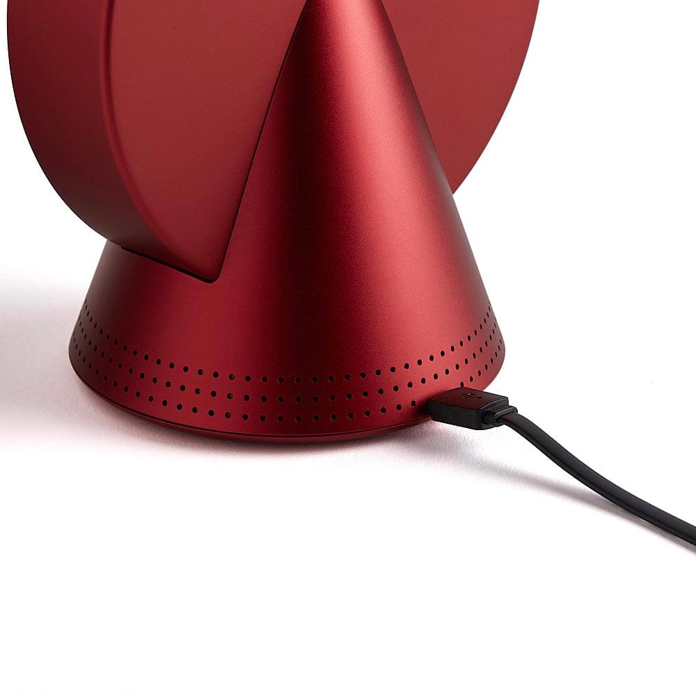 Red conic alarm clock radio with speaker grille base and power cable port