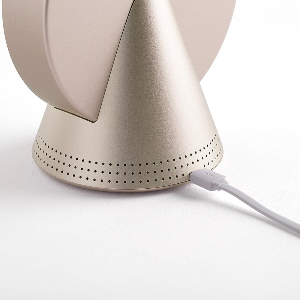 Gold conic radio alarm clock with Bluetooth speaker; bottom view with power cable