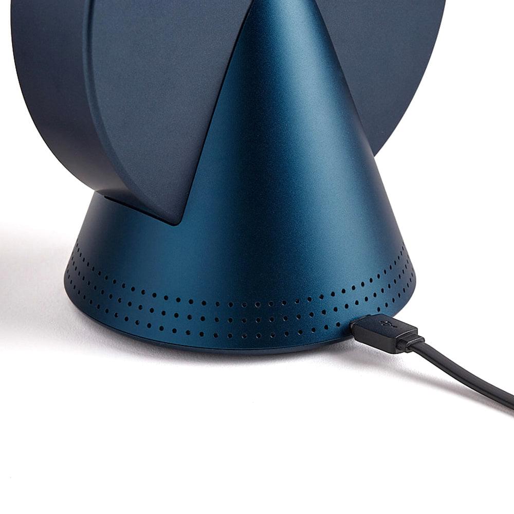 Blue conic radio alarm clock speaker base with ventilation holes and attached cable