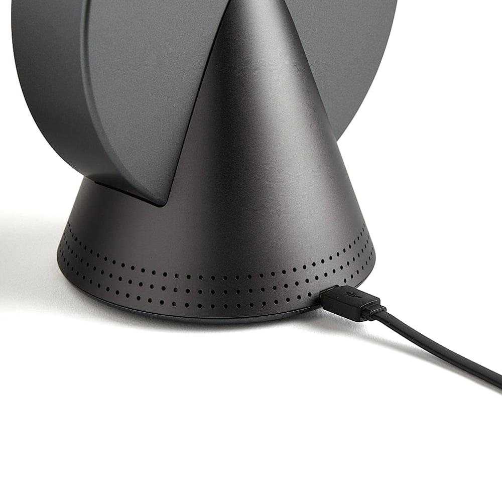 Grey conic alarm clock radio with perforated speaker grille and power cable at base