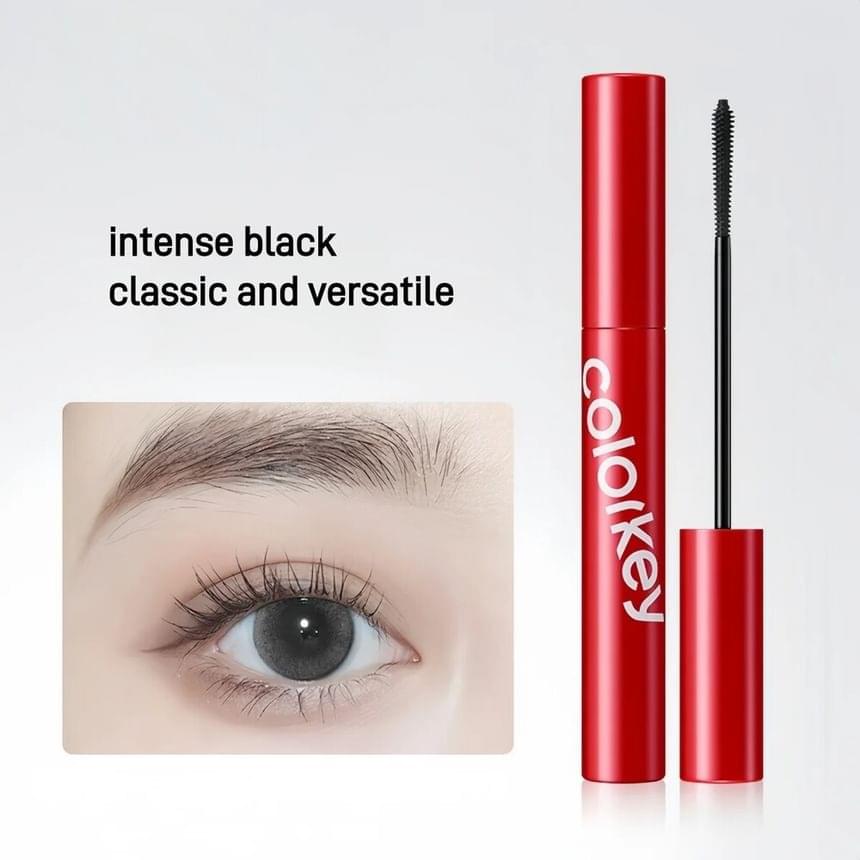 Red mascara tube with separate black-bristled brush for long curl definition