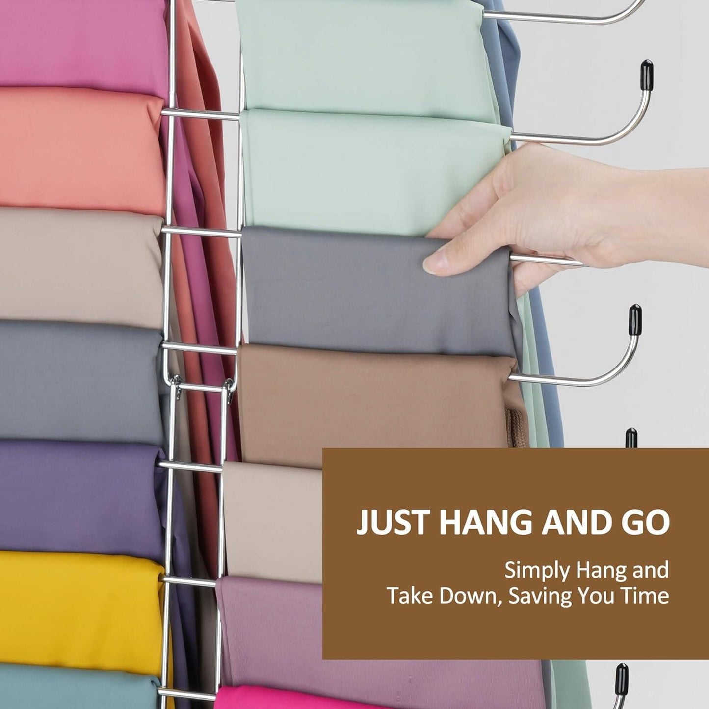 Legging organizer with silver hangers holding folded leggings; hand adjusts a hook