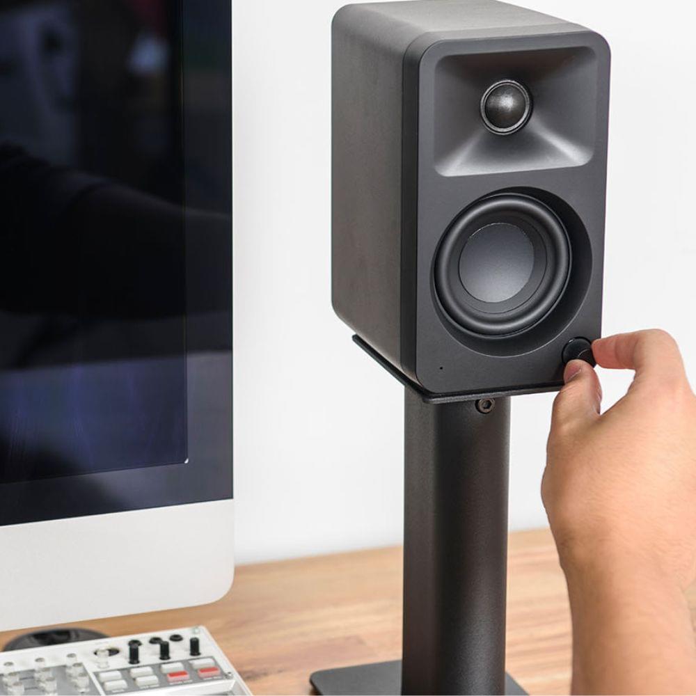 Kanto ORA powered desktop speaker being adjusted on a stand, black