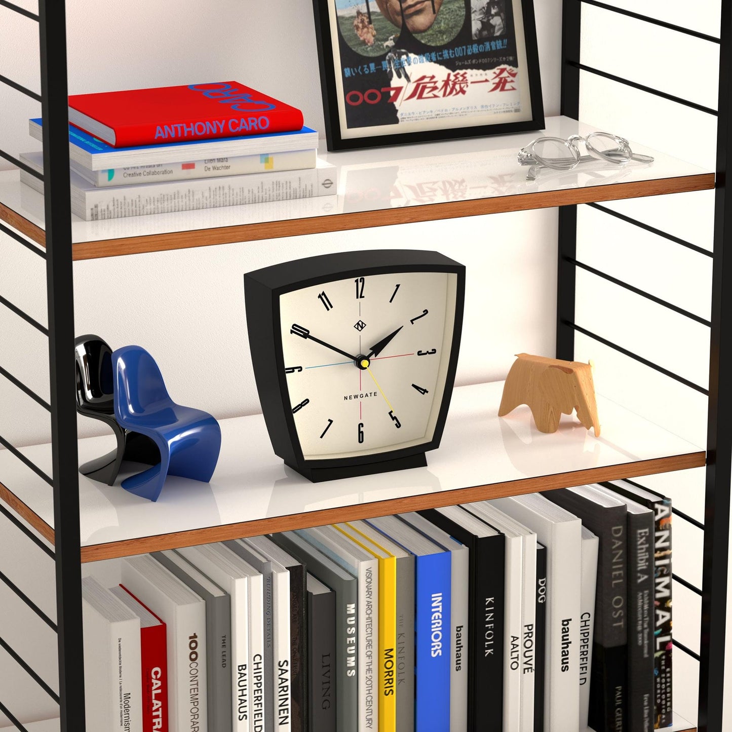 Black mantel clock on shelf, cream dial with bold numerals and black hands