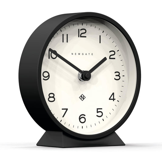 Black mantle clock with tilted view, white dial, and black hands