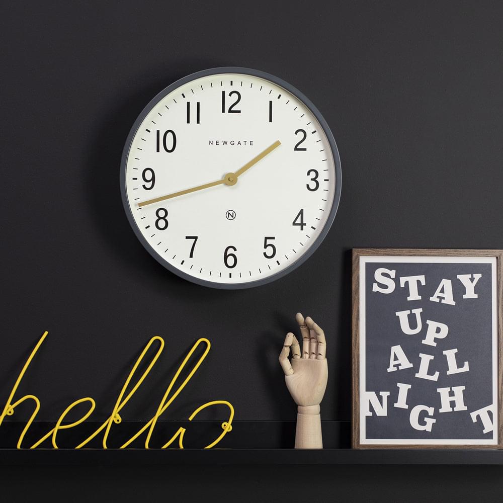 Small round wall clock, matte grey frame, cream dial, gold hands, Arabic numerals