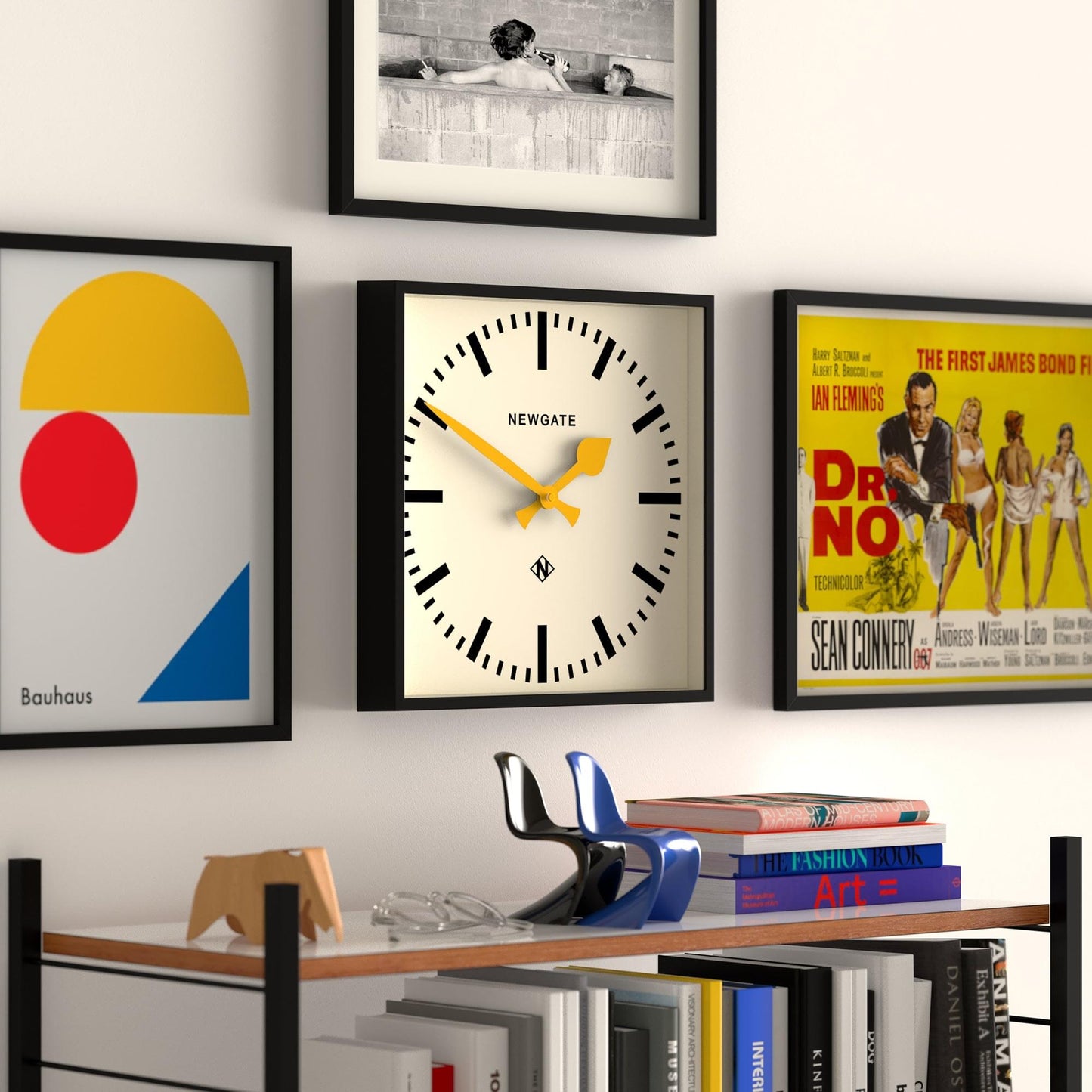 Newgate wall clock with black frame, cream face, and yellow hour and minute hands