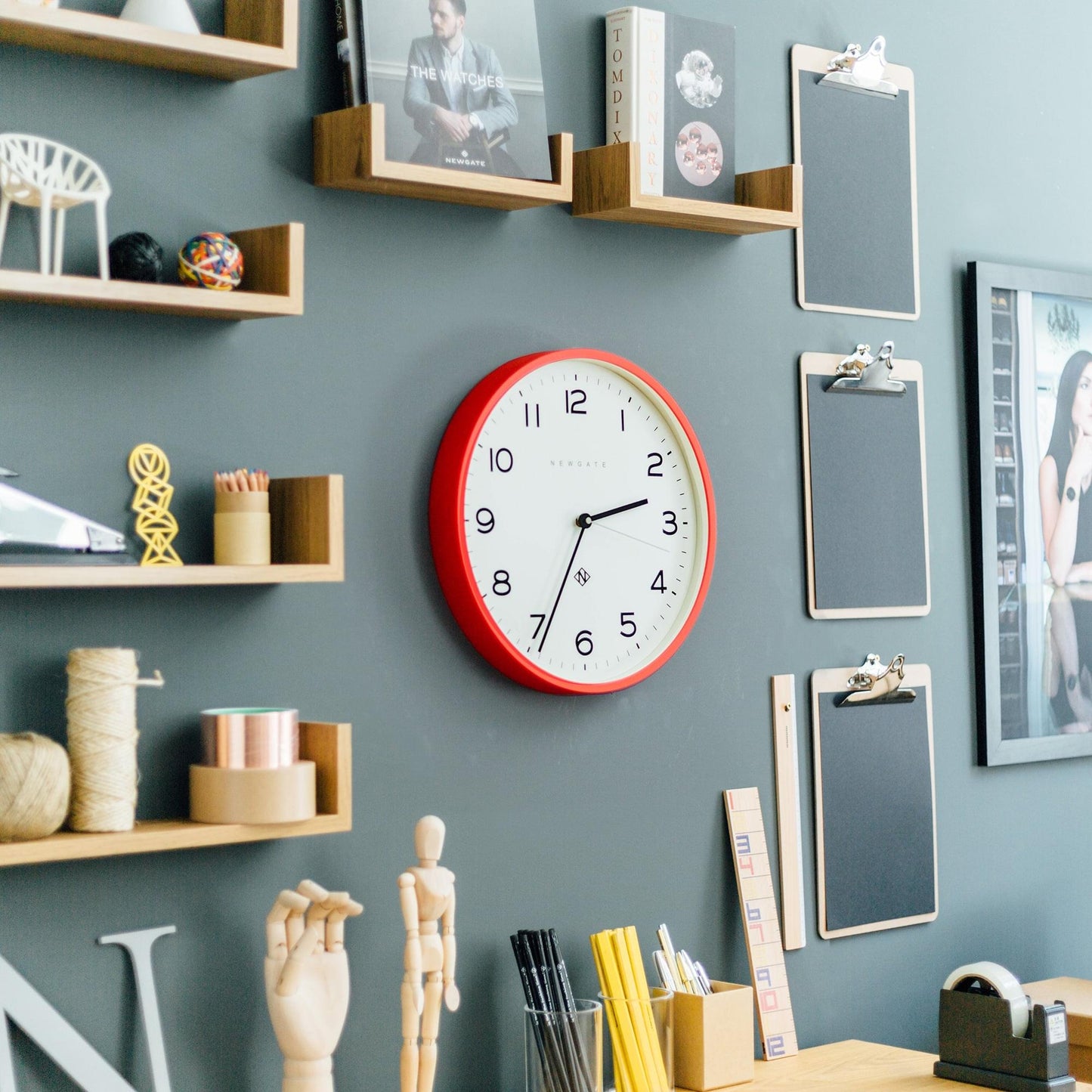 Red wall clock with cream face, black numerals and hands, circular red bezel