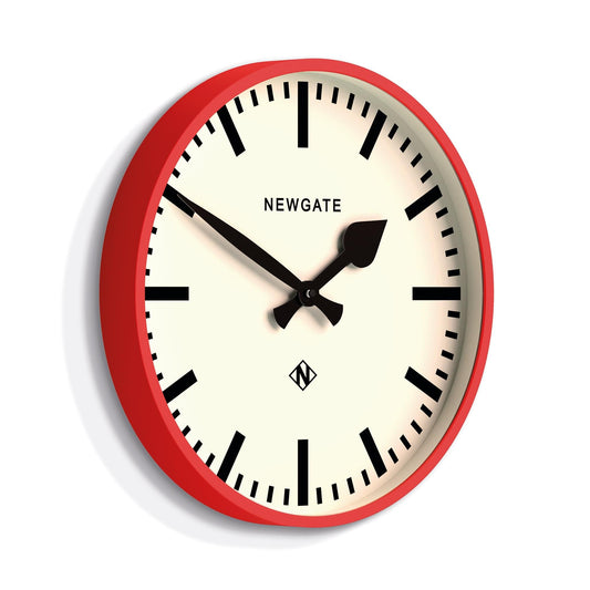 Red wall clock with white face, black hour and minute hands, rail-style marks