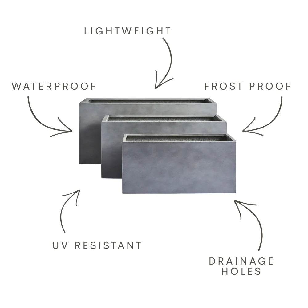Oblong rectangular planter set in concrete grey with drainage holes
