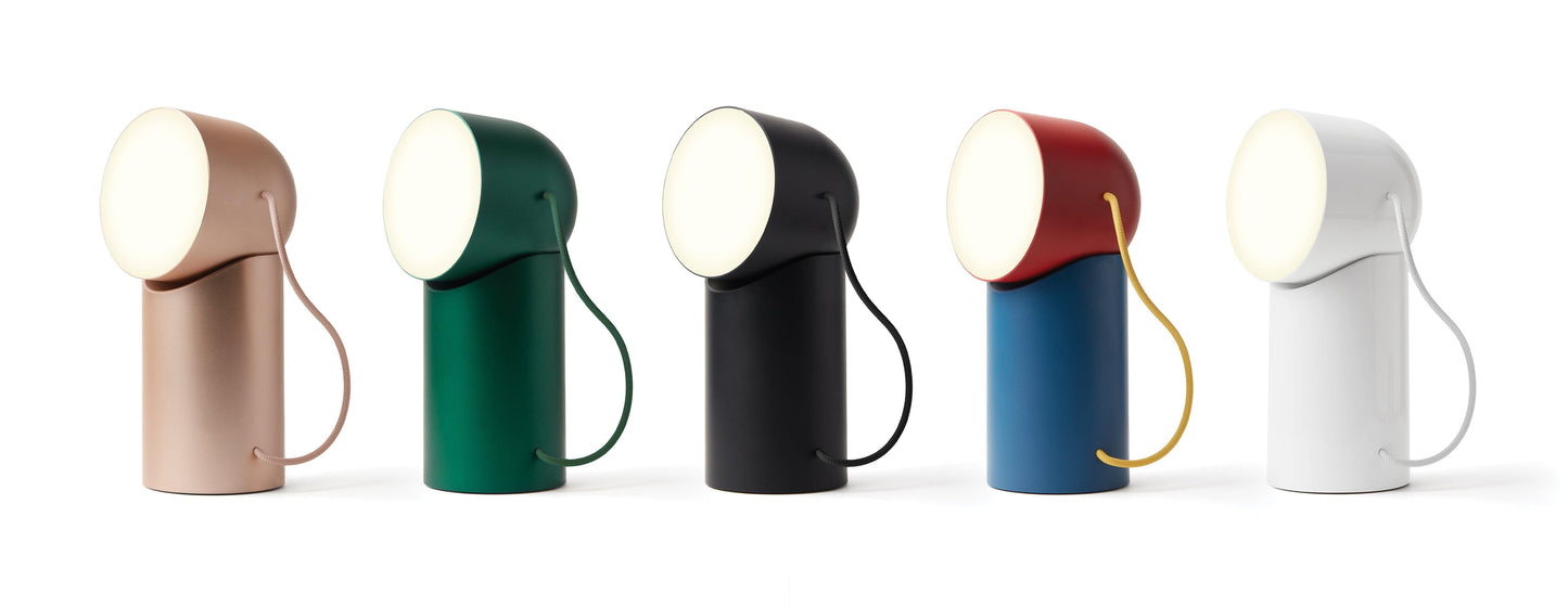 Assorted portable LED lamps with round diffusers in multiple colors and attached cords.