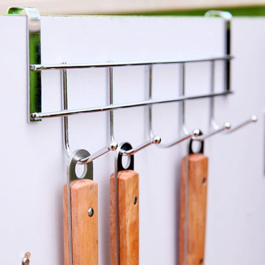 Silver over-door hook rack with four visible curved hooks holding wooden items