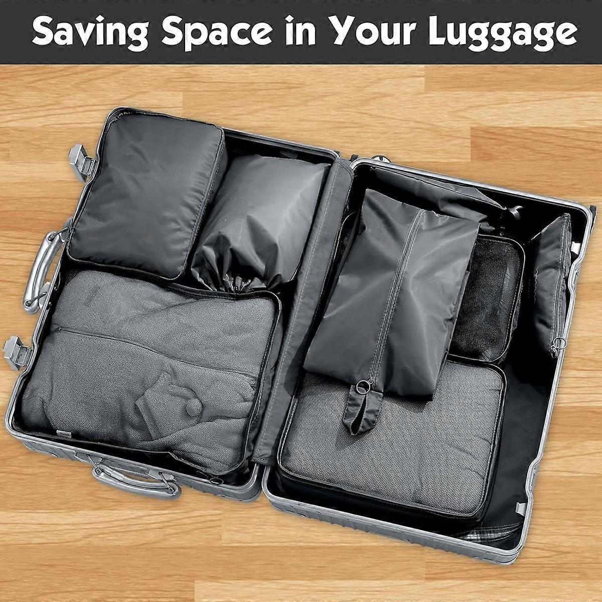 Travel packing cubes set, dark gray folded compartments in open suitcase