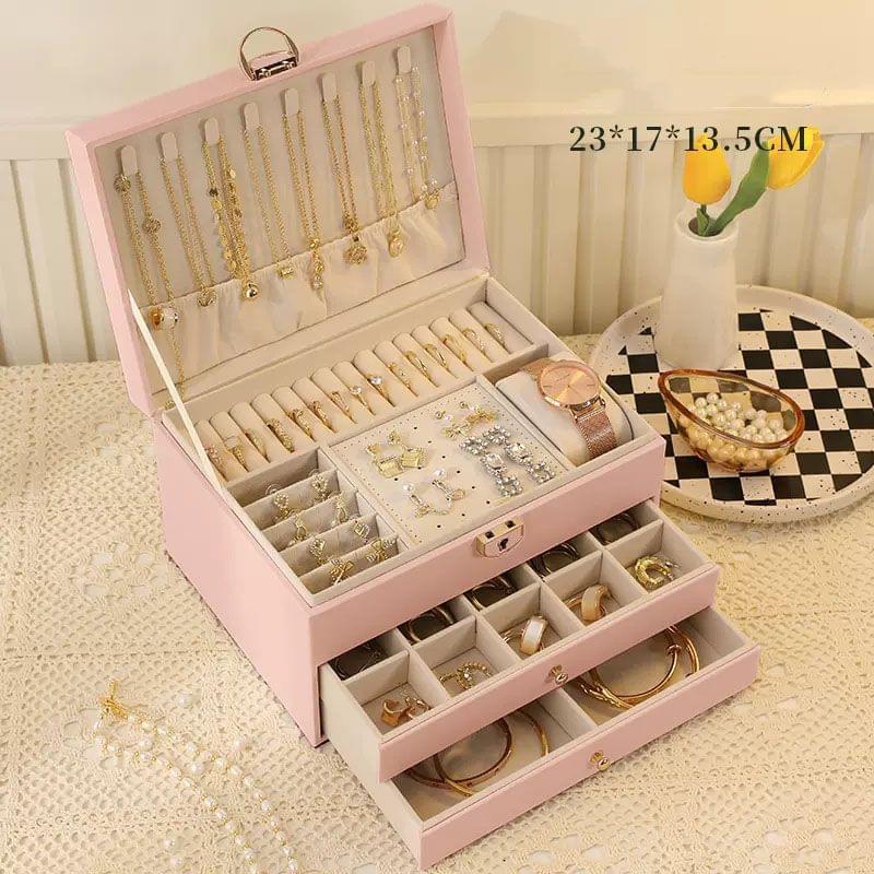 Pink lockable jewellery box open, three drawers with ring and bracelet compartments
