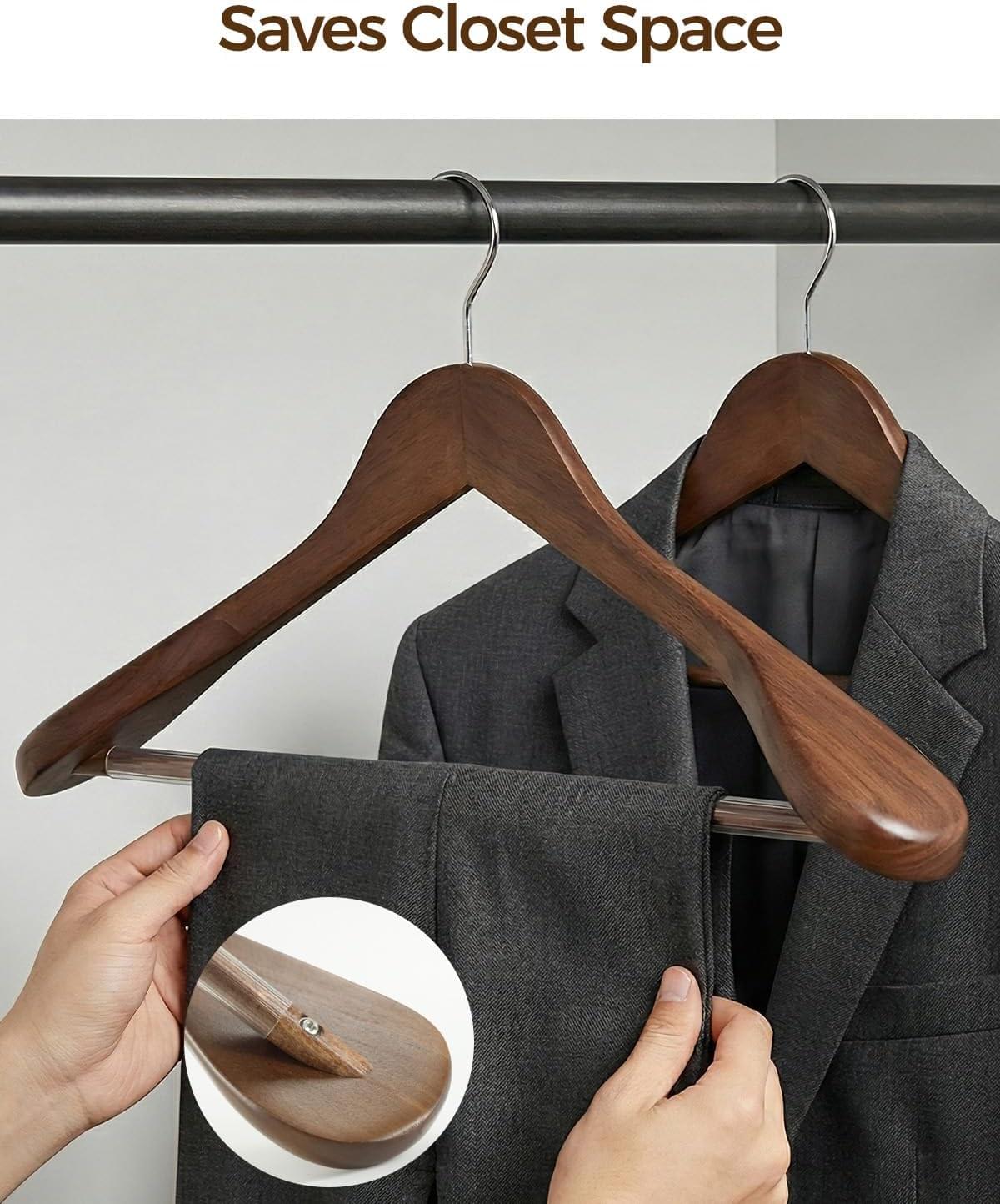 Wooden hanger with anti-slip rod tip, placed onto a closet rail by hand