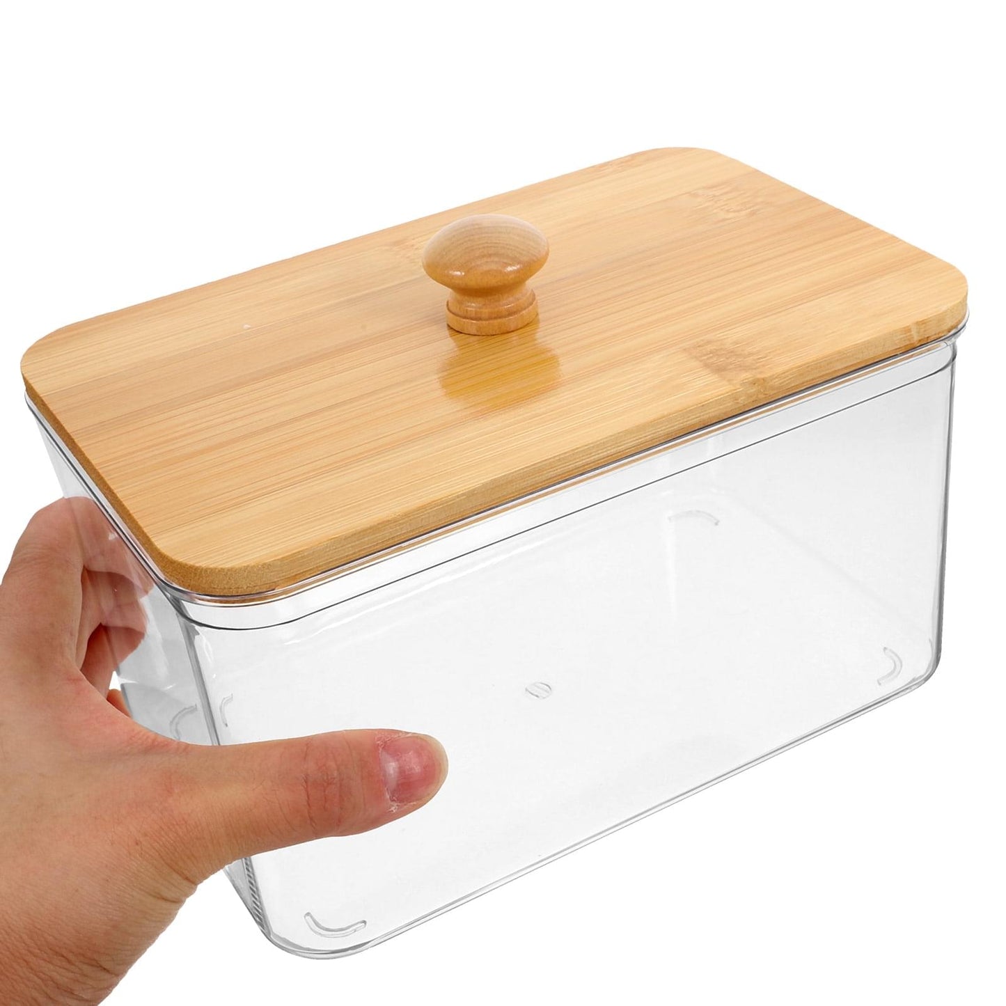 Hand holding clear laundry sheet container with bamboo lid and knob
