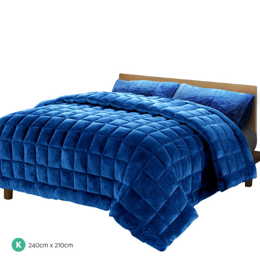 Blue faux mink quilt with diamond quilting and draped overhang, king size.