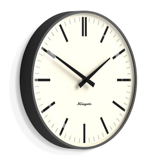 Newgate wall clock angled view; black frame, cream dial, bold black markers and minute hand