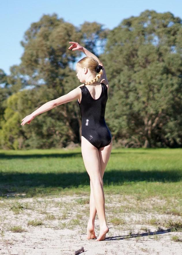 Black sleeveless leotard side view with scoop back and high leg
