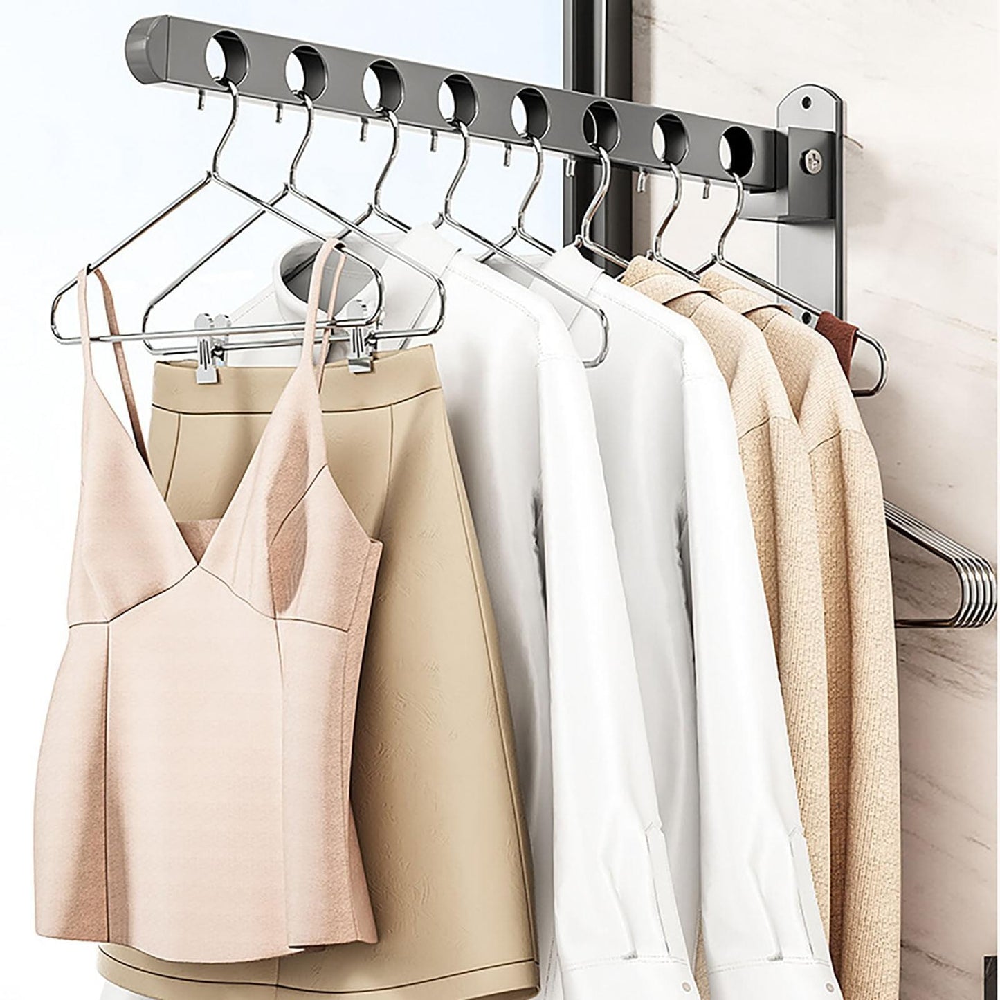 Matte grey wall clothes hanger rack with oval hooks holding shirts on hangers