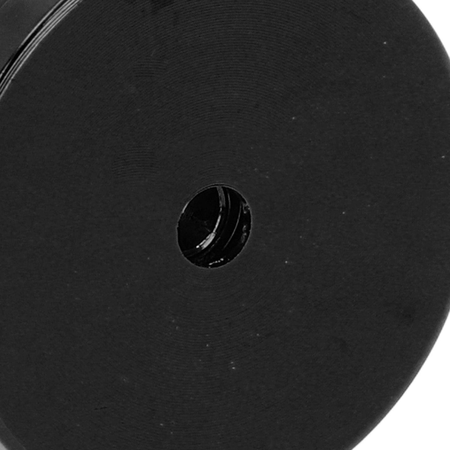 Black wall hook base underside showing circular mounting hole