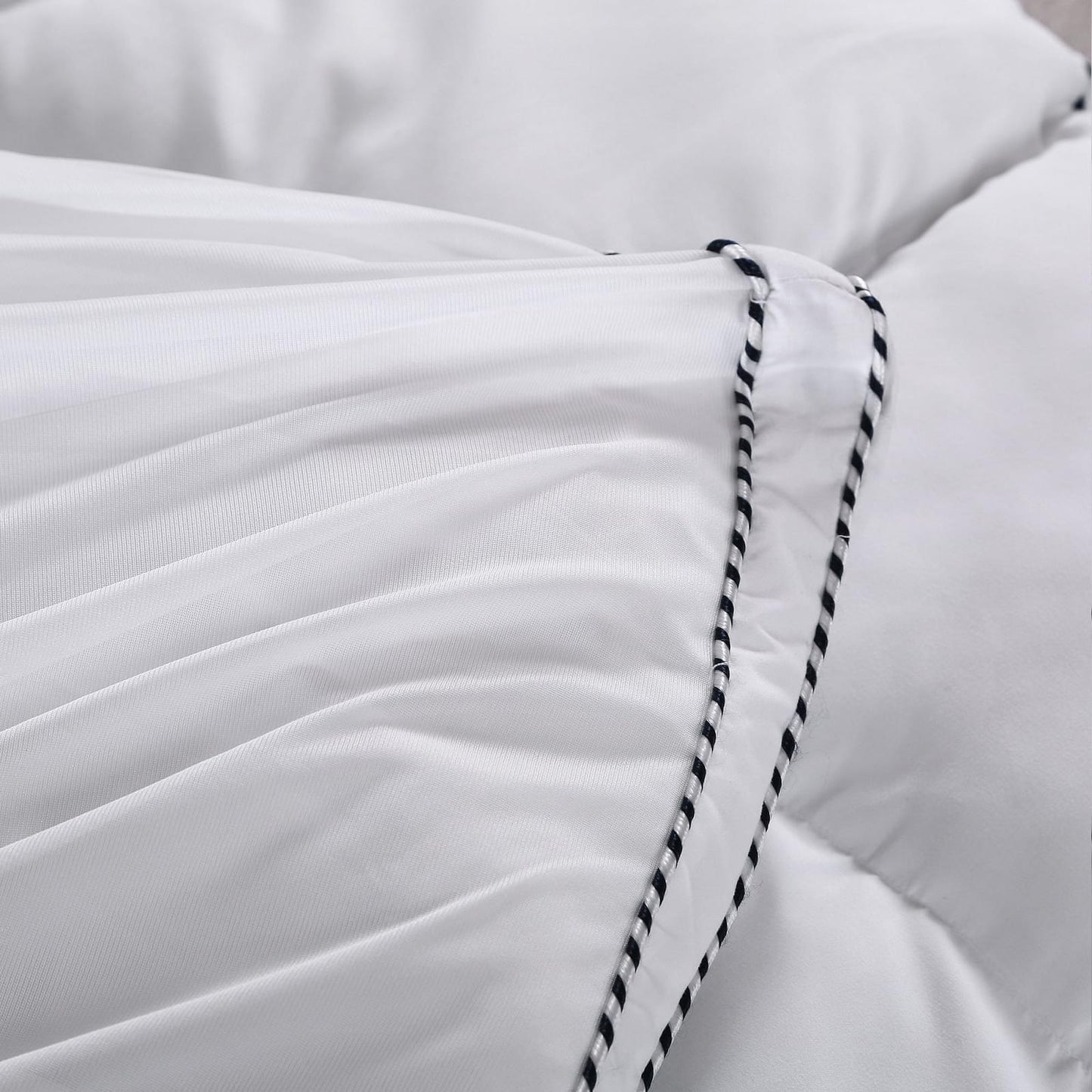 White mattress pad topper cover corner with black-and-white striped piping