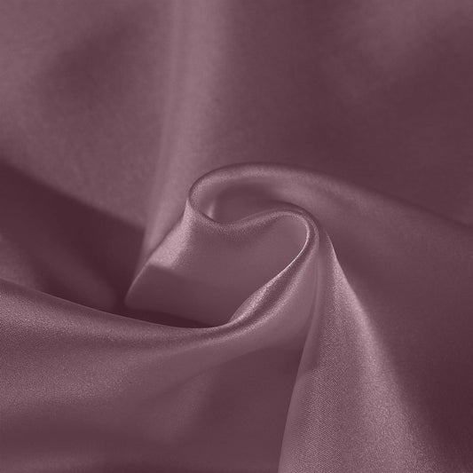 Mulberry silk pillow case fabric close-up in mauve-wine with smooth satin sheen folds.