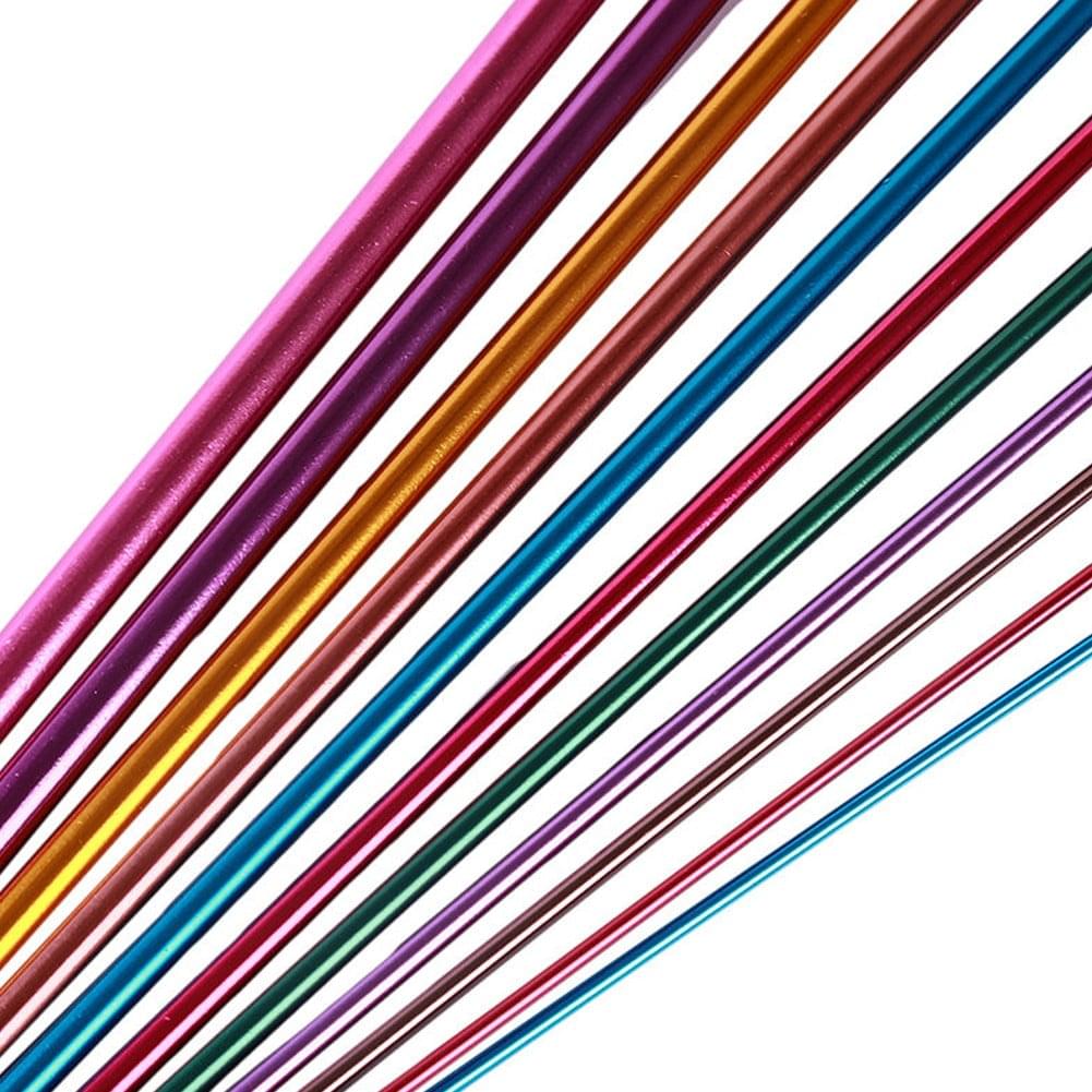 Row of long Tunisian crochet hooks with glossy colored aluminum shafts and white size tips