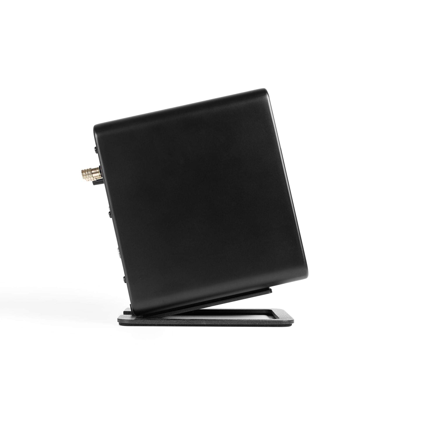 Black angled speaker stand propping a small speaker at an upward angle