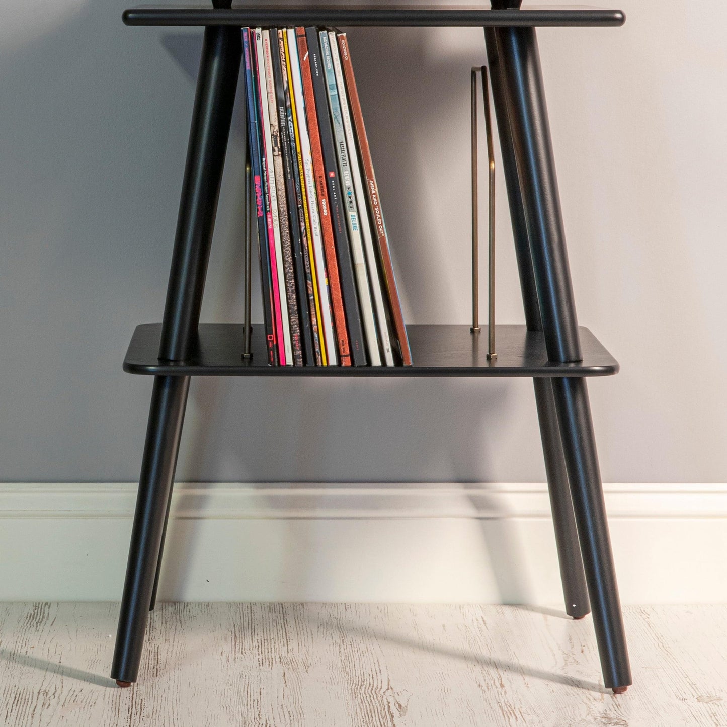 Black two-tier turntable stand showing space for records on shelf