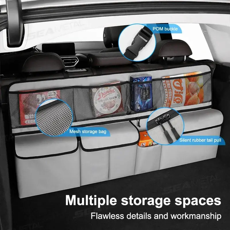 Gray car seat back organizer with mesh pocket, rubber pull tab, and divided storage bins