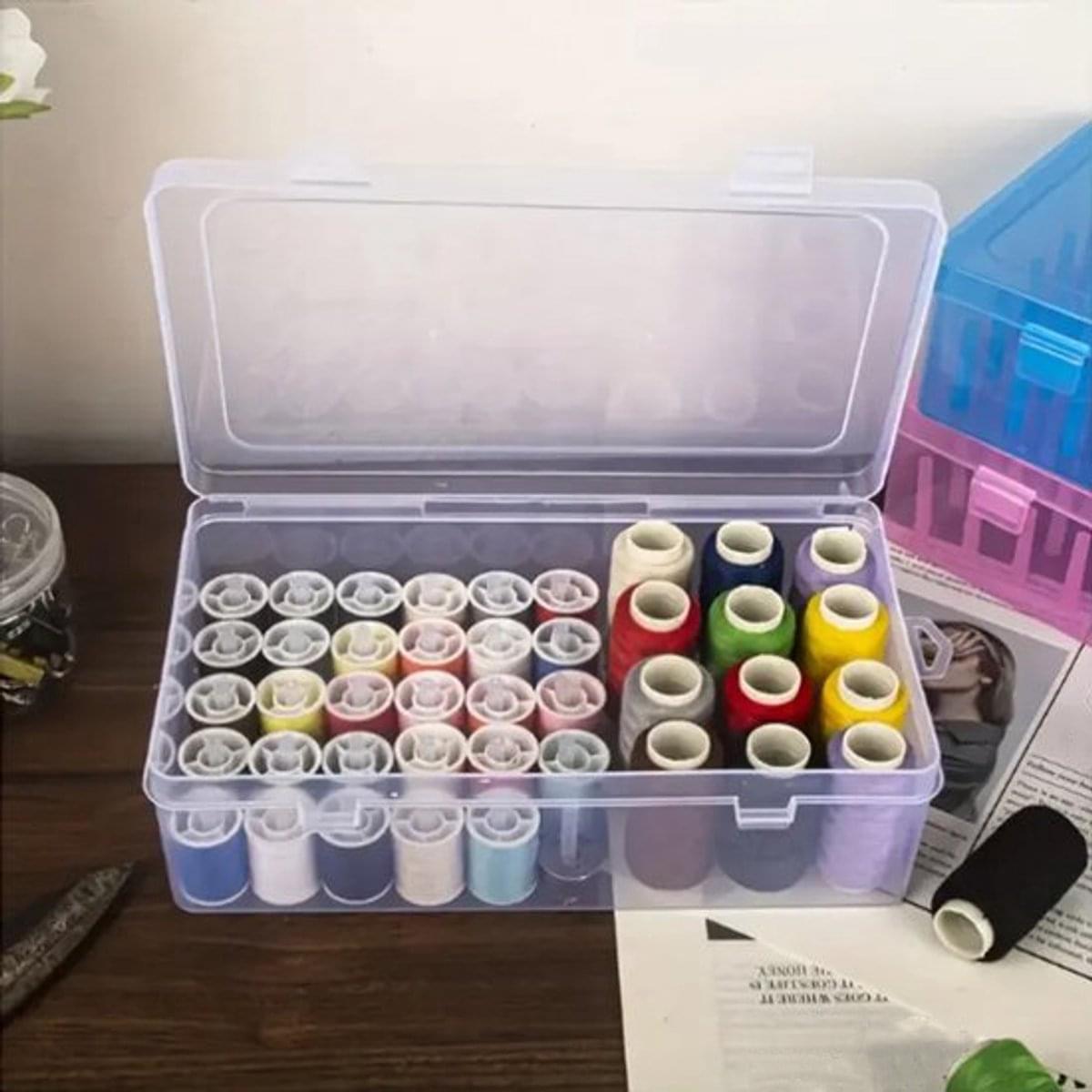 Clear plastic thread storage box with divided tray for multiple sewing thread spools