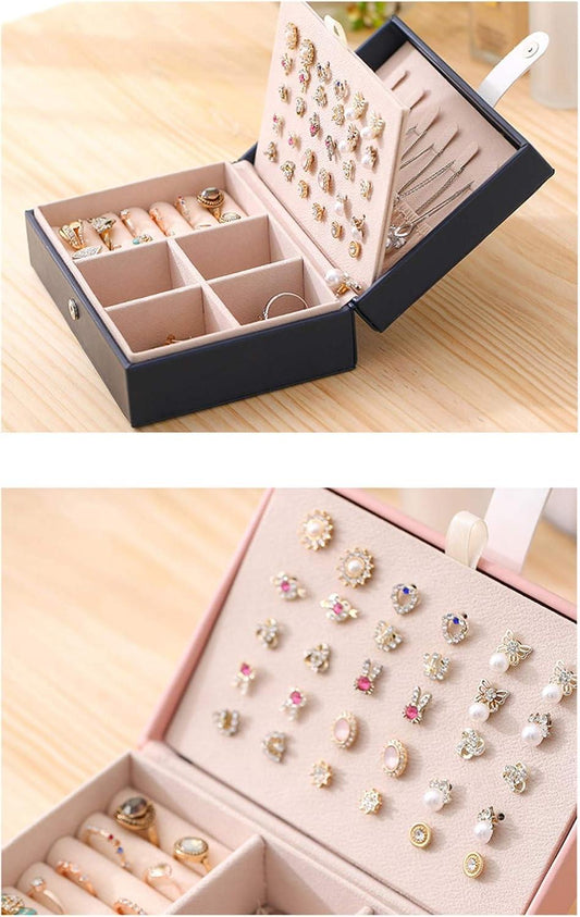 Dark PU leather jewelry storage box open, showing ring/earring organizer compartments.