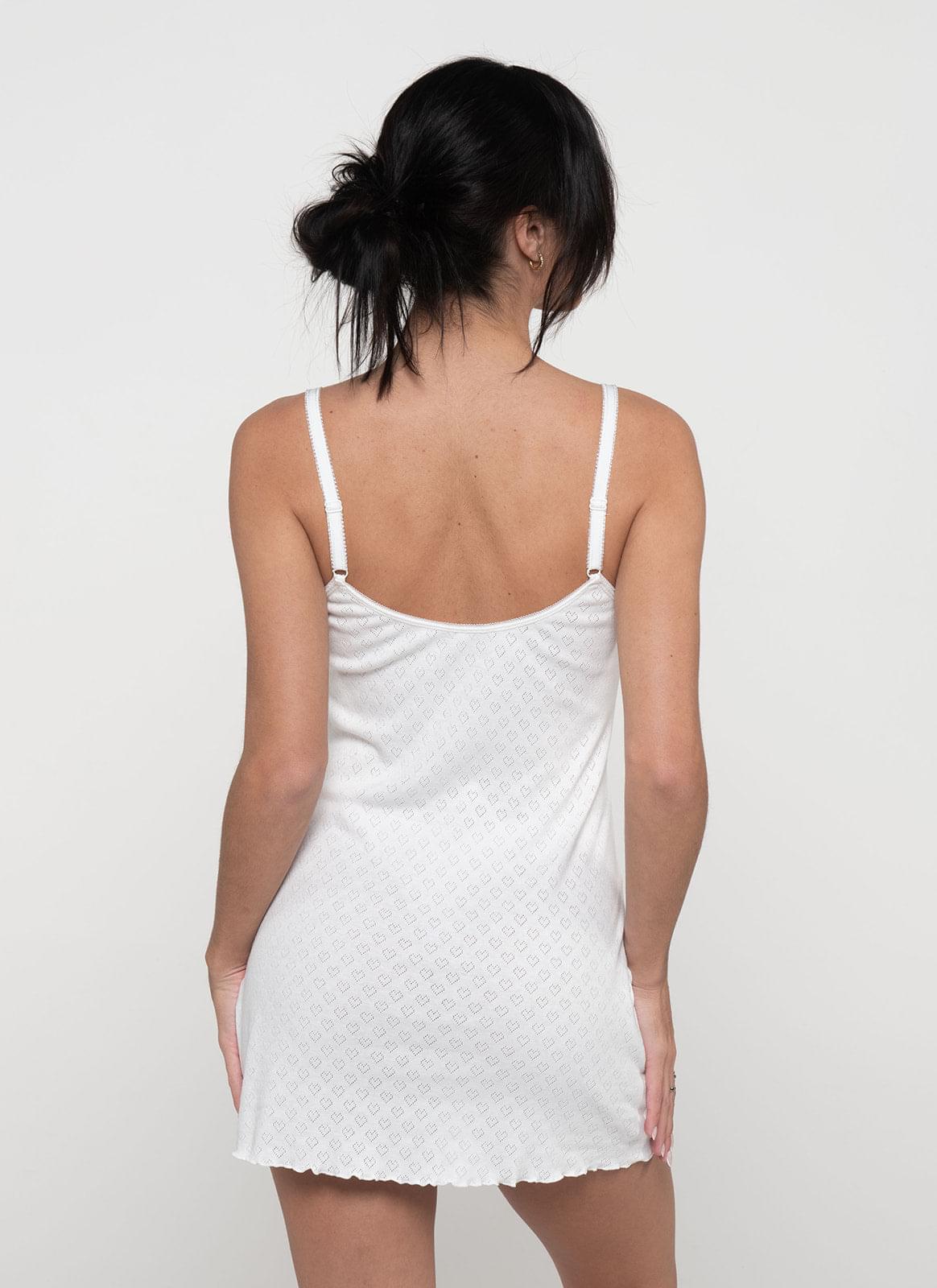 Back view of white cotton vintage nightdress with spaghetti straps and scalloped hem